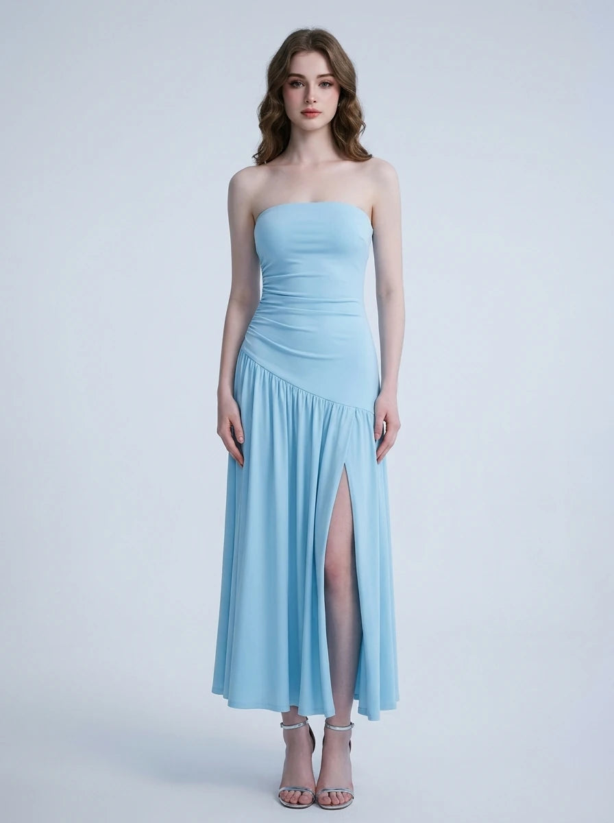 Woman wearing a sky blue strapless ruched jersey knit A-line evening dress with an asymmetrical hemline and side slit