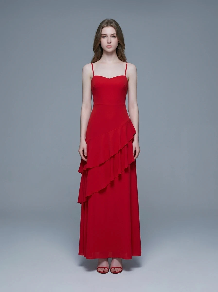 Woman wearing a red, floor-length, spaghetti strap dress with a sweetheart neckline and tiered ruffle detailing on the front