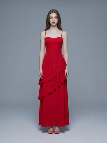 Woman wearing a red, floor-length, spaghetti strap dress with a sweetheart neckline and tiered ruffle detailing on the front