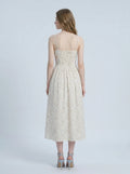 Back view of a woman in a floral print midi dress.