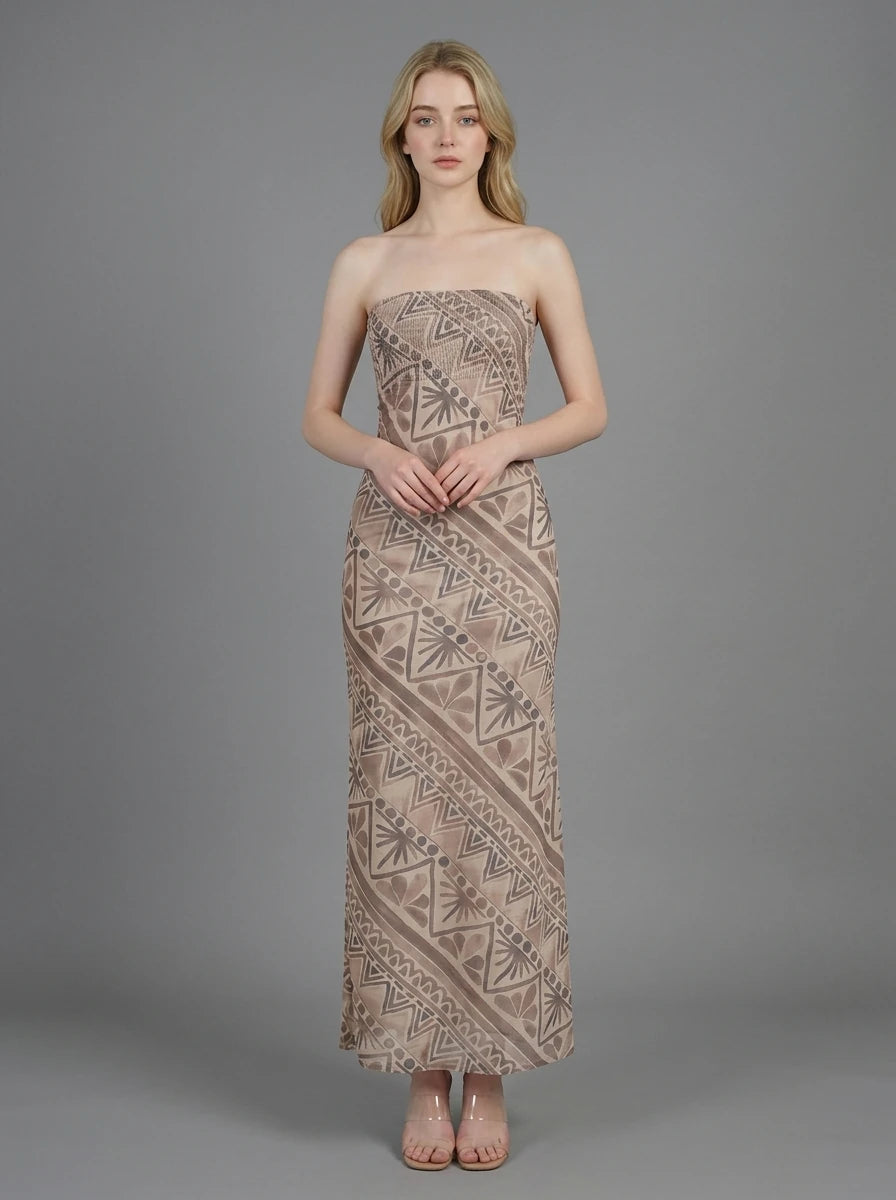 Woman in a strapless geometric print maxi dress