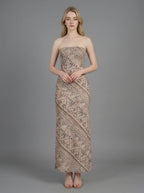 Woman in a strapless geometric print maxi dress