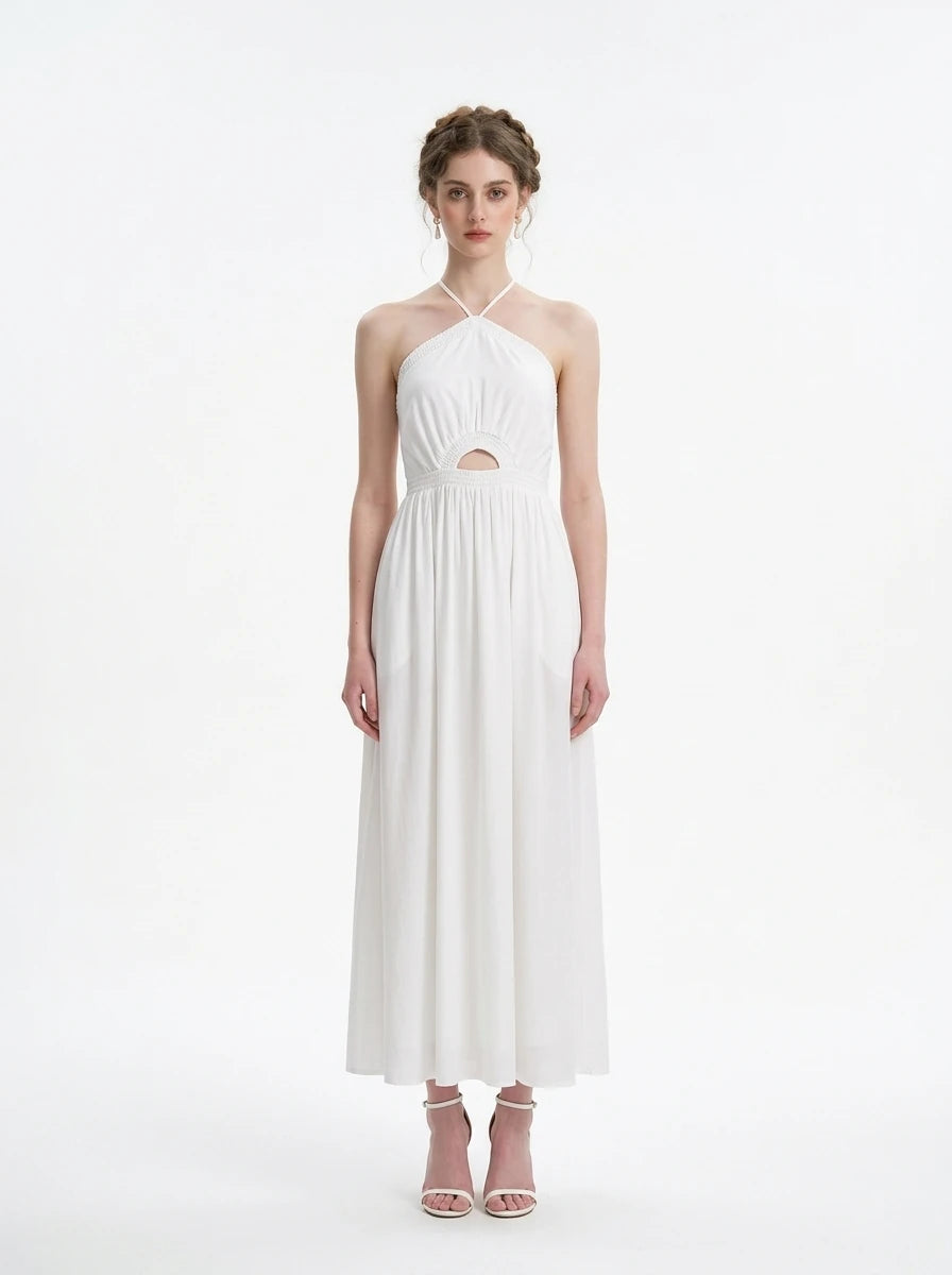 Woman wearing a white halter neck midi dress with a cut-out detail and empire waist