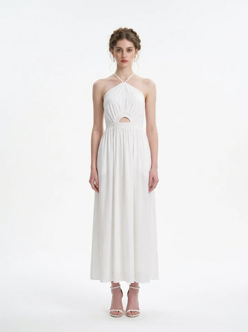 Woman wearing a white halter neck midi dress with a cut-out detail and empire waist