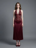 Woman wearing a burgundy lace and satin halter neck dress