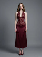 Woman wearing a burgundy lace and satin halter neck dress