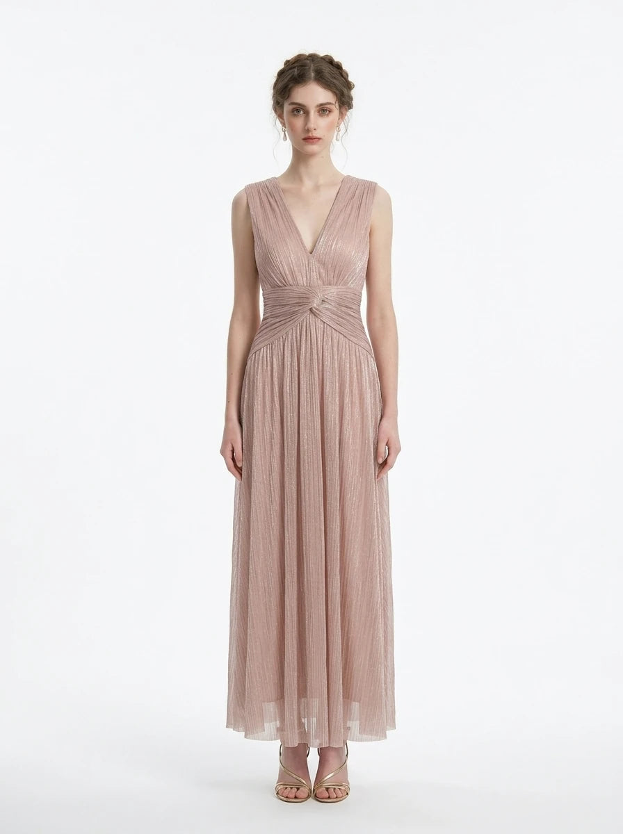 woman in a rose gold metallic a-line maxi dress with a v-neckline and ruched empire waist