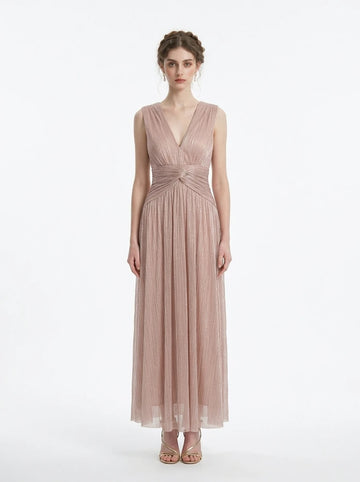 woman in a rose gold metallic a-line maxi dress with a v-neckline and ruched empire waist