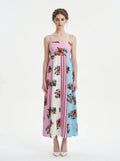 Woman wearing a colorblock floral print maxi dress with spaghetti straps