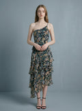 Woman wearing a floral print one-shoulder chiffon dress with a tiered, asymmetrical ruffle skirt.