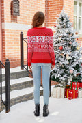 Back view of a woman in a red Christmas sweater with snowflake patterns.