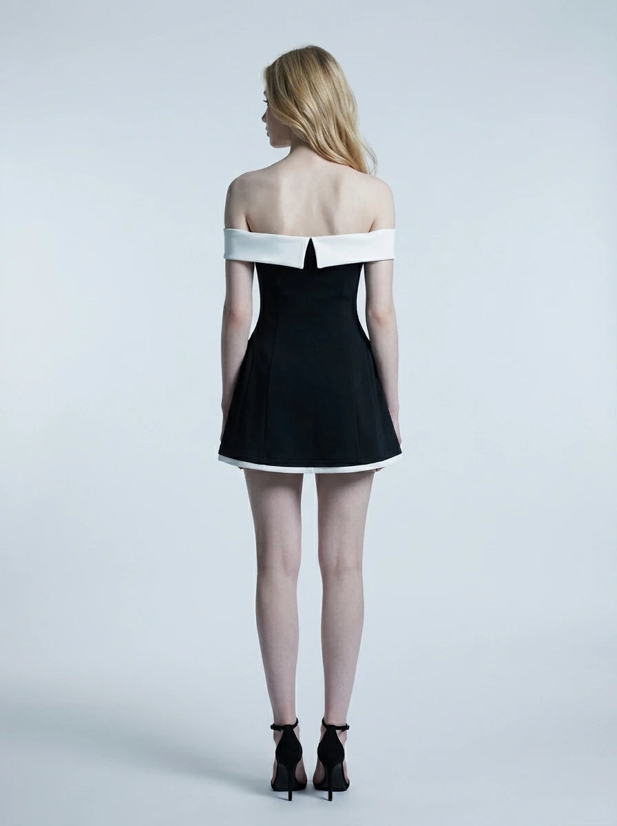 Woman in a black off-the-shoulder dress with white trim, back view