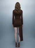 Model wearing a long-sleeved brown ruched mini dress with an asymmetrical hemline and high neckline, back view
