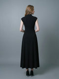 Back view of a woman in a sleeveless black A-line midi dress.