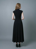 Back view of a woman in a sleeveless black A-line midi dress.