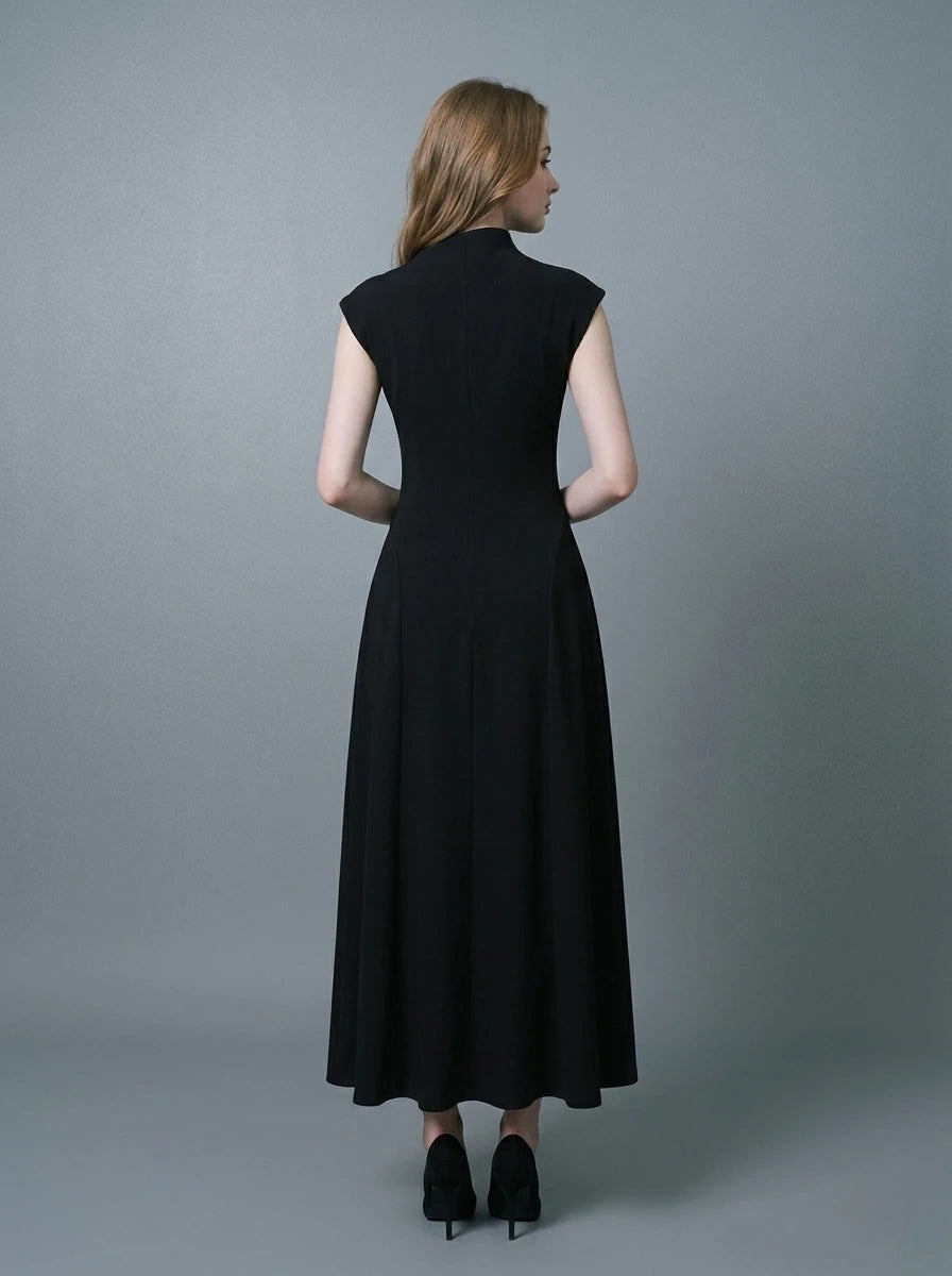 Back view of a woman in a sleeveless black A-line midi dress.