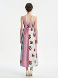 Back view of a woman in a colorblock floral print maxi dress