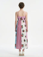 Back view of a woman in a colorblock floral print maxi dress