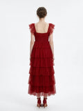 Back view of a woman in a red tiered tulle dress with ruffled cap sleeves