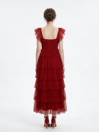 Back view of a woman in a red tiered tulle dress with ruffled cap sleeves