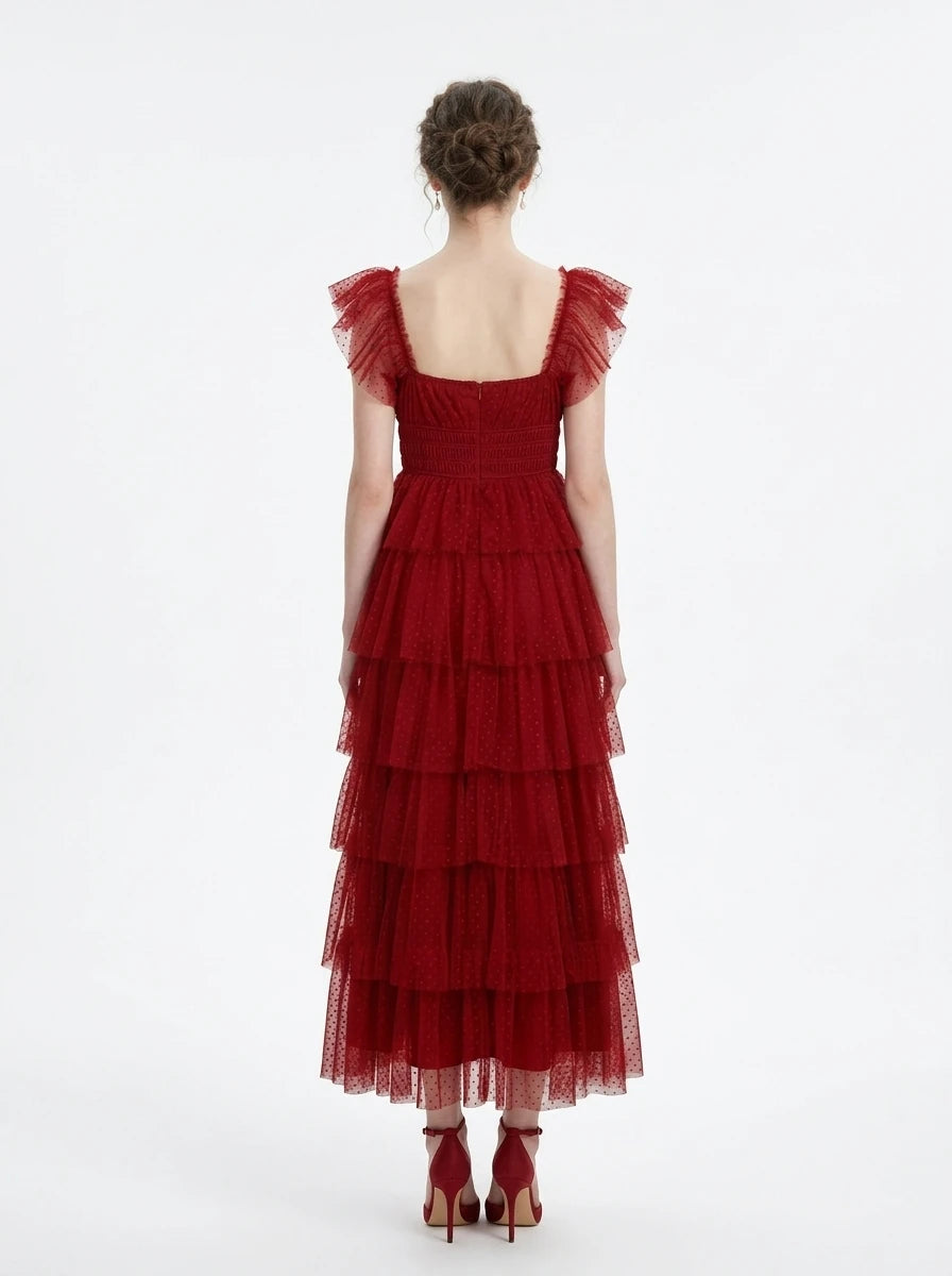 Back view of a woman in a red tiered tulle dress with ruffled cap sleeves