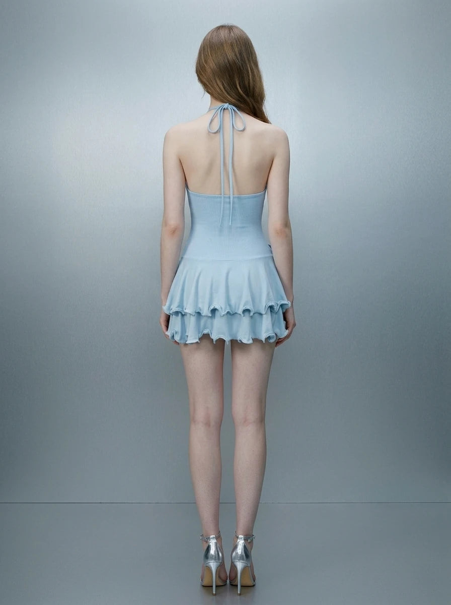 Woman wearing a light blue ruffled halter dress