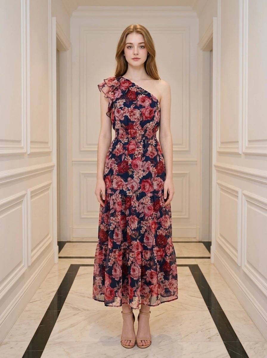 Woman wearing a navy floral print one-shoulder midi dress with a tiered skirt.