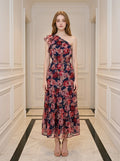 Woman wearing a navy floral print one-shoulder midi dress with a tiered skirt.