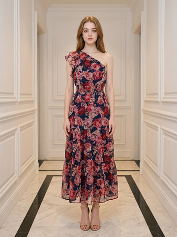 Woman wearing a navy floral print one-shoulder midi dress with a tiered skirt.