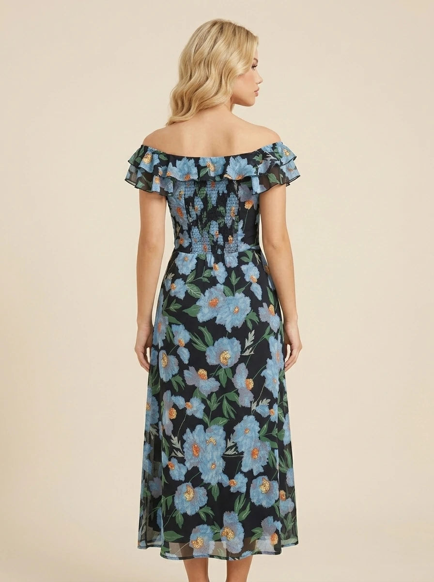 Woman wearing a black floral print off-the-shoulder midi dress with blue flowers and ruffle trim