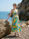 Woman in a strapless floral print midi dress with the sea in the background