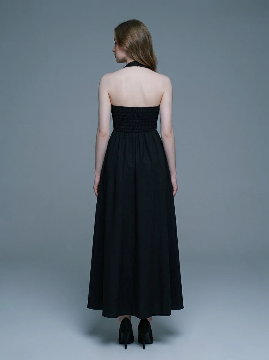 woman wearing a black midi halter dress with a square neckline
