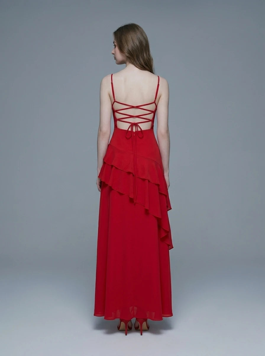 Back view of a woman in a red, floor-length, spaghetti strap dress with a sweetheart neckline and criss-cross back straps