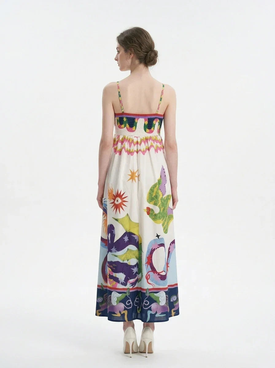 Woman wearing a white midi dress with a colorful graphic print and spaghetti straps from the back