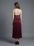 Back view of a burgundy lace and satin halter neck dress