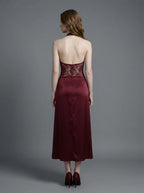 Back view of a burgundy lace and satin halter neck dress