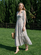 Woman in a floral print midi dress walking on grass in a backyard