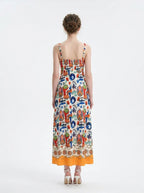 Back view of a woman in a colorful printed A-line midi dress.