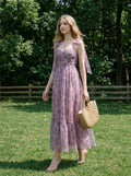 Woman in a floral print dress walking in a grassy field