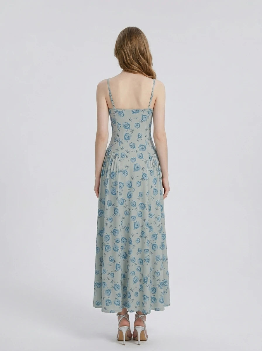 Woman wearing a light blue floral print midi dress with spaghetti straps