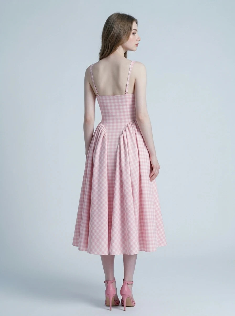 back view of a woman in a pink gingham midi dress