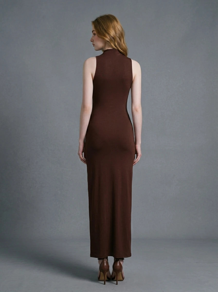 Woman wearing a long brown sleeveless mock neck dress with a knotted waist detail.