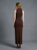 Back view of a woman in a brown sleeveless mock neck maxi dress