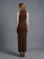 Back view of a woman in a brown sleeveless mock neck maxi dress