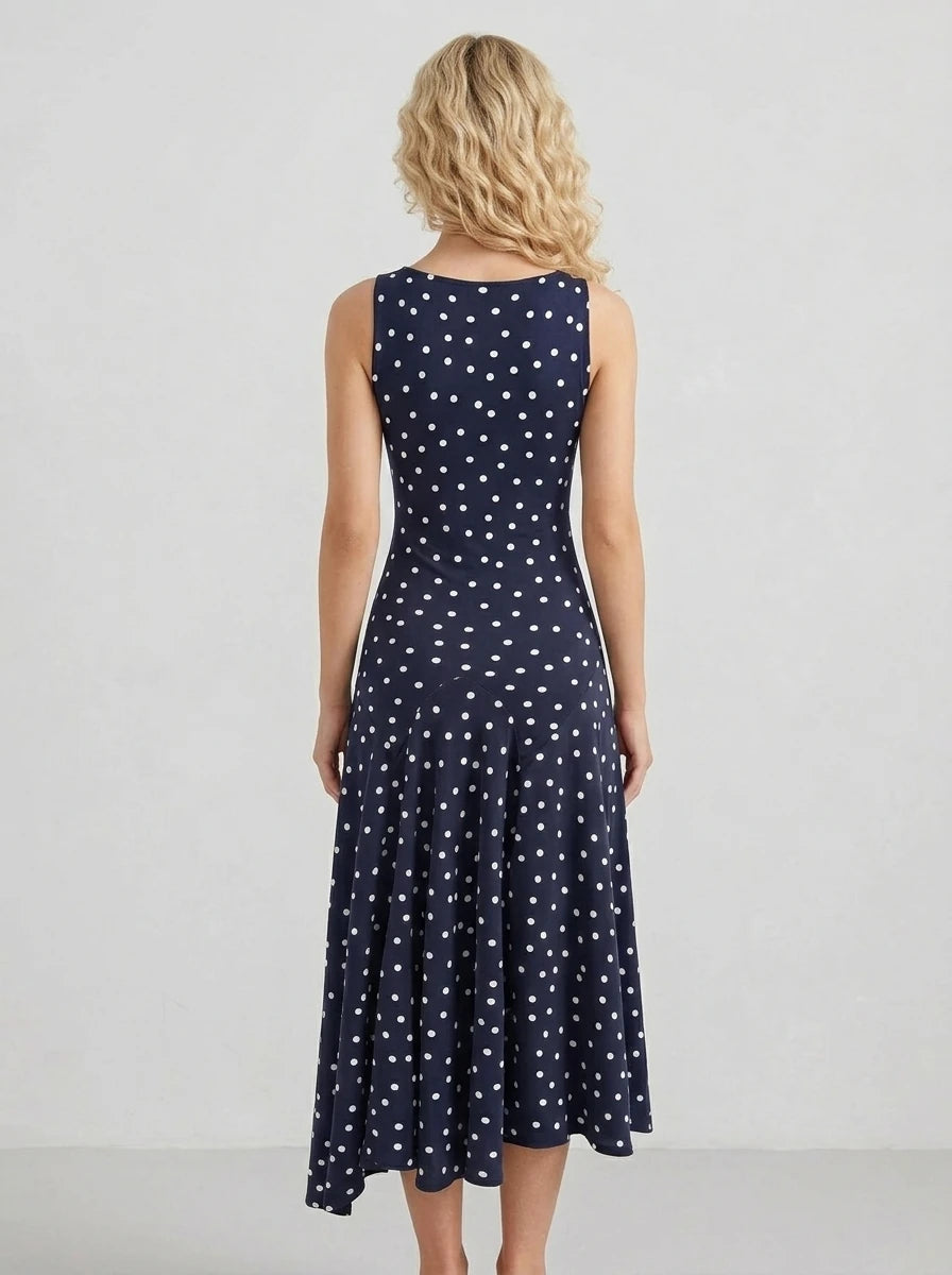 Woman wearing a navy blue polka dot midi dress