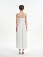 Back view of a woman in a white halter neck midi dress