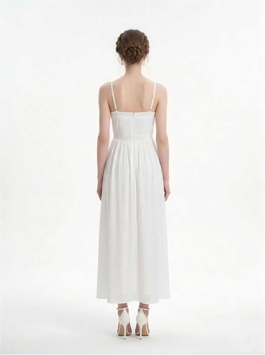 Back view of a woman in a white halter neck midi dress