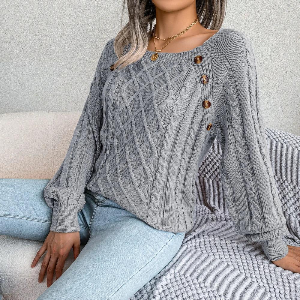 Woman lounging on a couch in a grey cable knit sweater