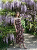 Woman in a strapless floral print chiffon maxi dress under wisteria
