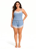 Woman wearing a light blue ribbed knit camisole and shorts set with white lace trim.